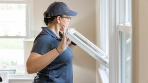 Tiffani Furrow inspecting a window